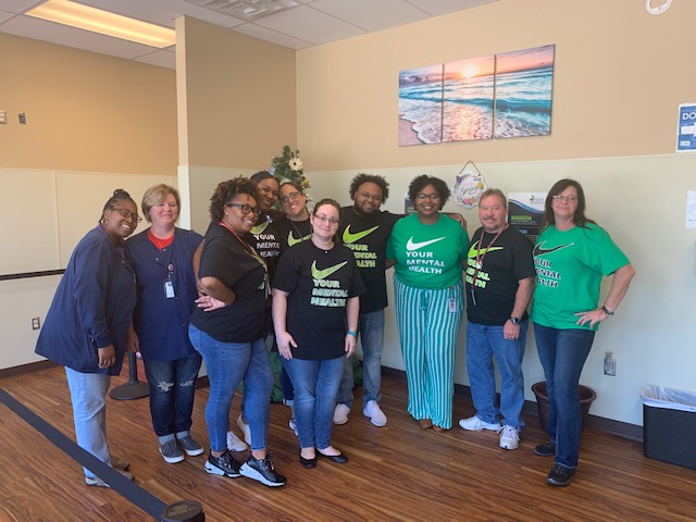 The healthcare providers at the New Season Biloxi Treatment Center recognize the importance of mental health in the month of May by wearing commemorative shirts, creating educational “Did You Know” posters and serving donuts to their patients. Pictured left to right: Nujuana Riley, RN, Brandy Byrd, LPN, Ashley Hall, counselor, Kasey Graben, counselor, Ariel Watson, counselor, Jennifer Neff, counselor, Quinta Anderson, counselor, Shelbi Lewis, counselor, Dean Jensen, counselor, and Shelly Pepitone, counselor.