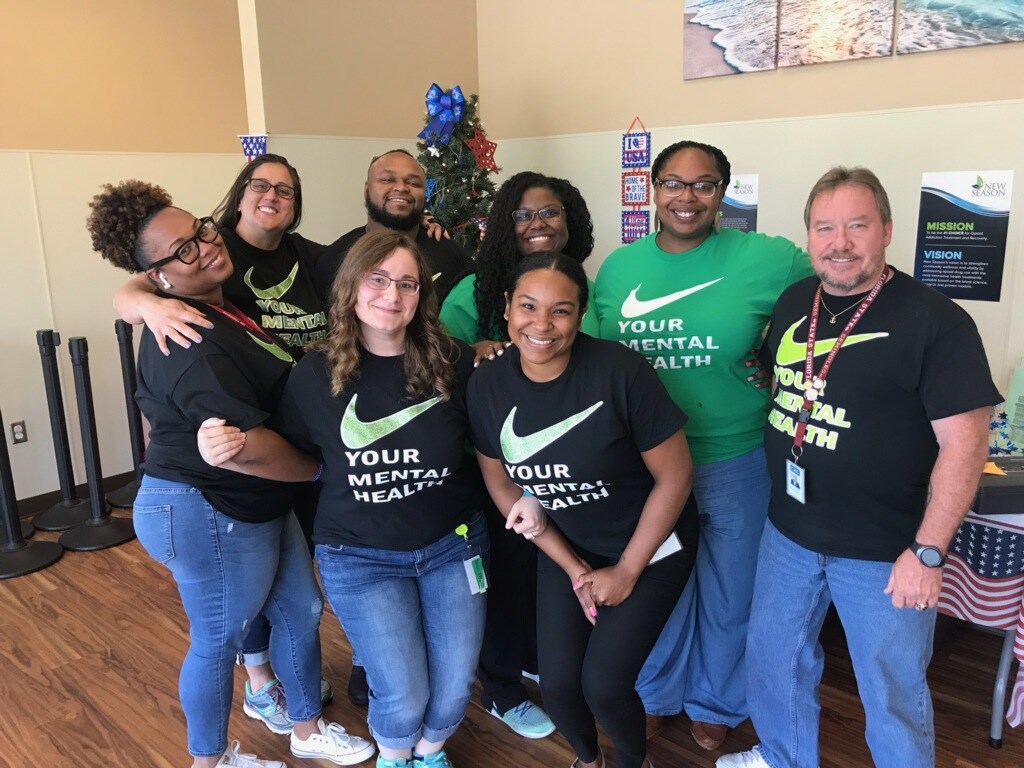 The team at the New Season Treatment Center in Biloxi, Miss., celebrates mental health awareness. Pictured left to right: Ashley Hall, recently departed counselor, Kasey Graben, counselor, Ariel Watson, counselor, Jennifer Neff, counselor, Arionna Johnson, RN, Shelbi Lewis, counselor, and Dean Jensen, counselor. 